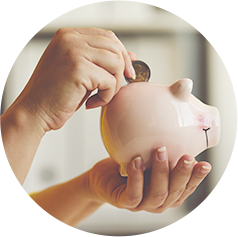 Person holding a piggy bank and putting a quarter in to save money.