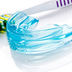 mouthguard next to a toothbrush